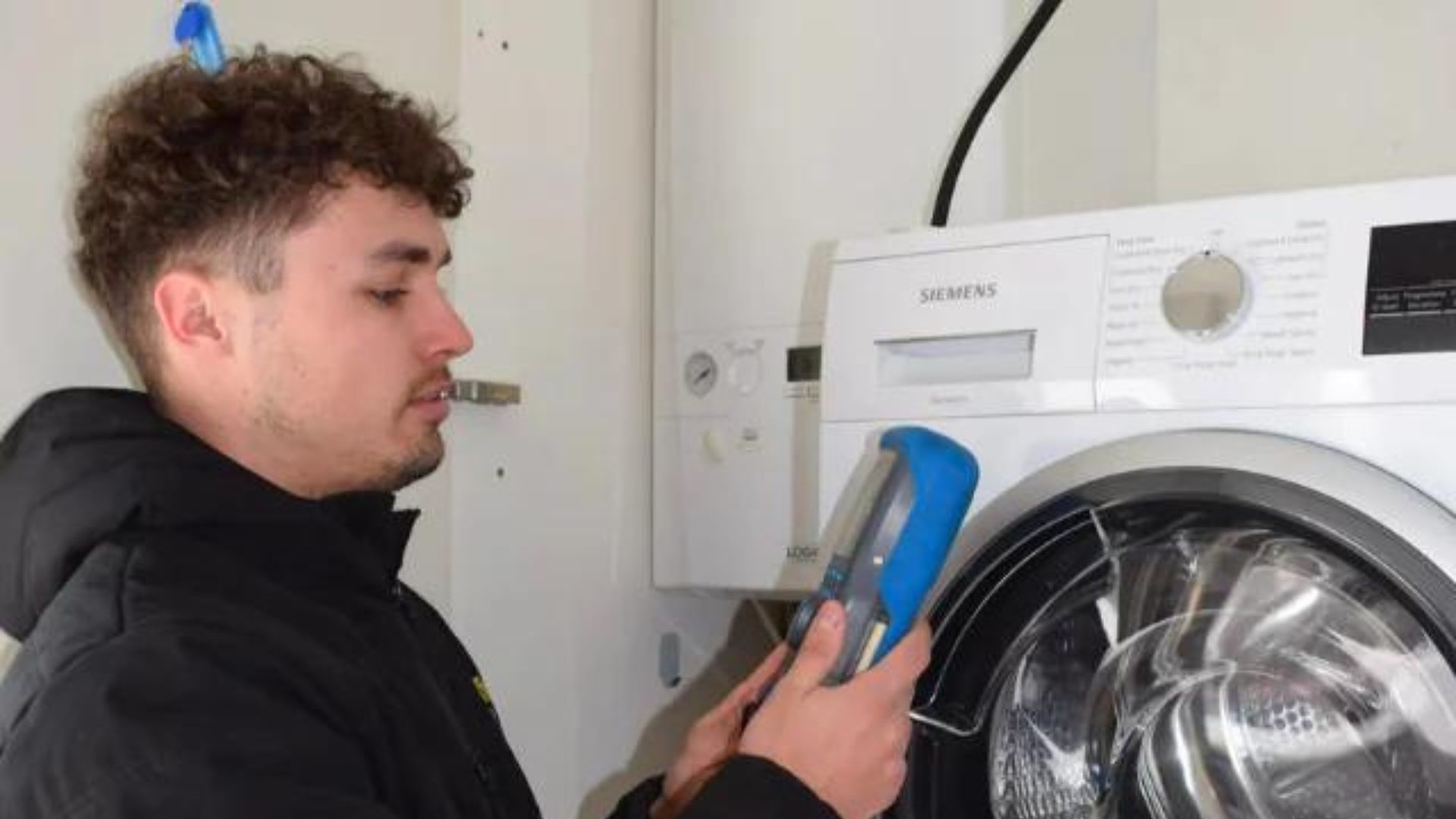 0800 Homefix Plumbing & Heating Engineer checking boiler with a measuring device