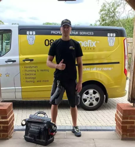 0800 Homefix engineer in front of work van 0800 Homefix Plumbing & Heating Engineer Standing outside of house with work tools