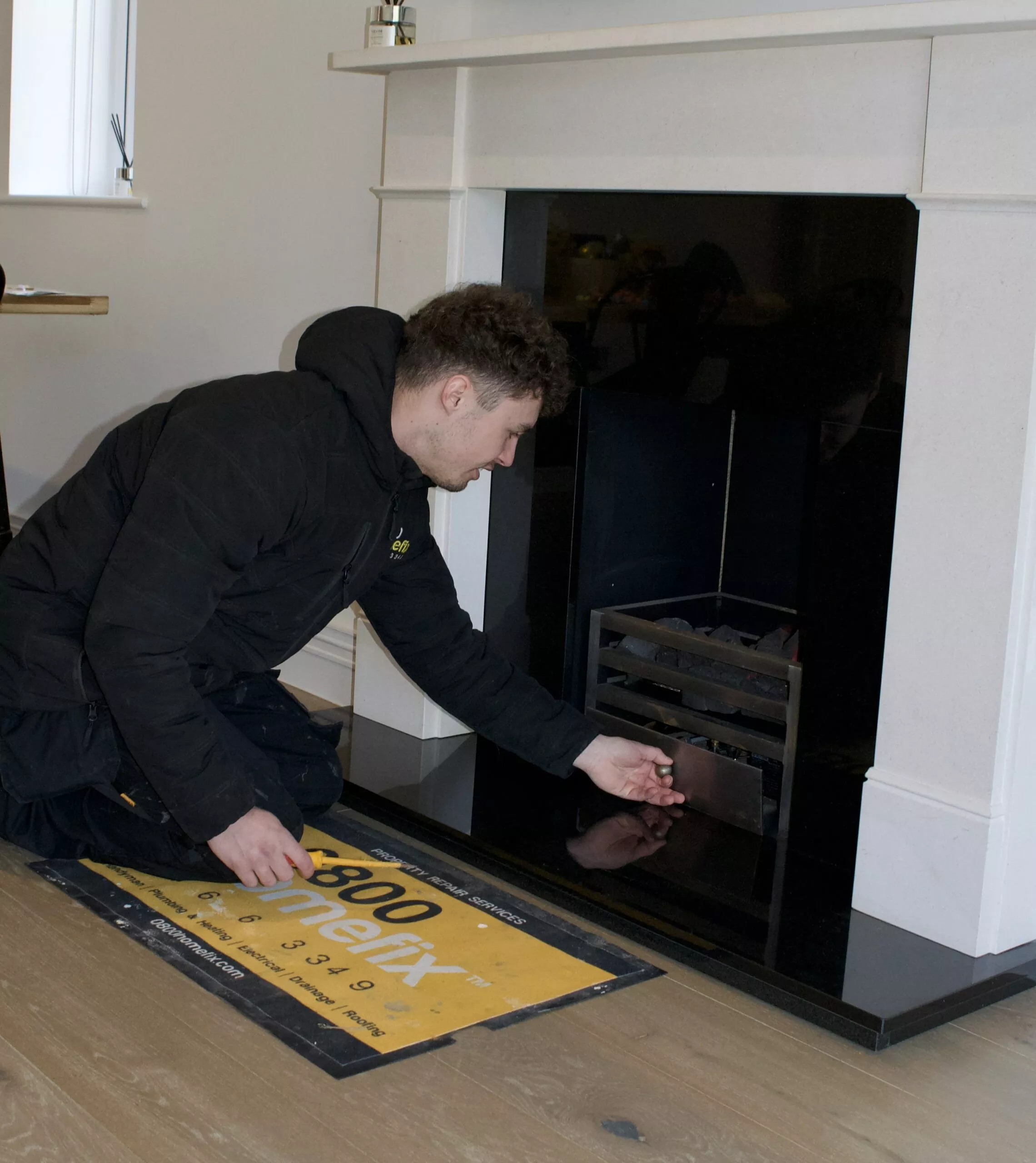 Gas Engineer Checking A Fireplace Gas Appliance